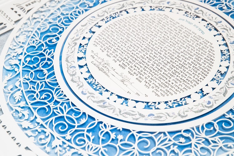 A close-up shot of a beautifully designed customized Ketubah, with intricate details and vivid colors