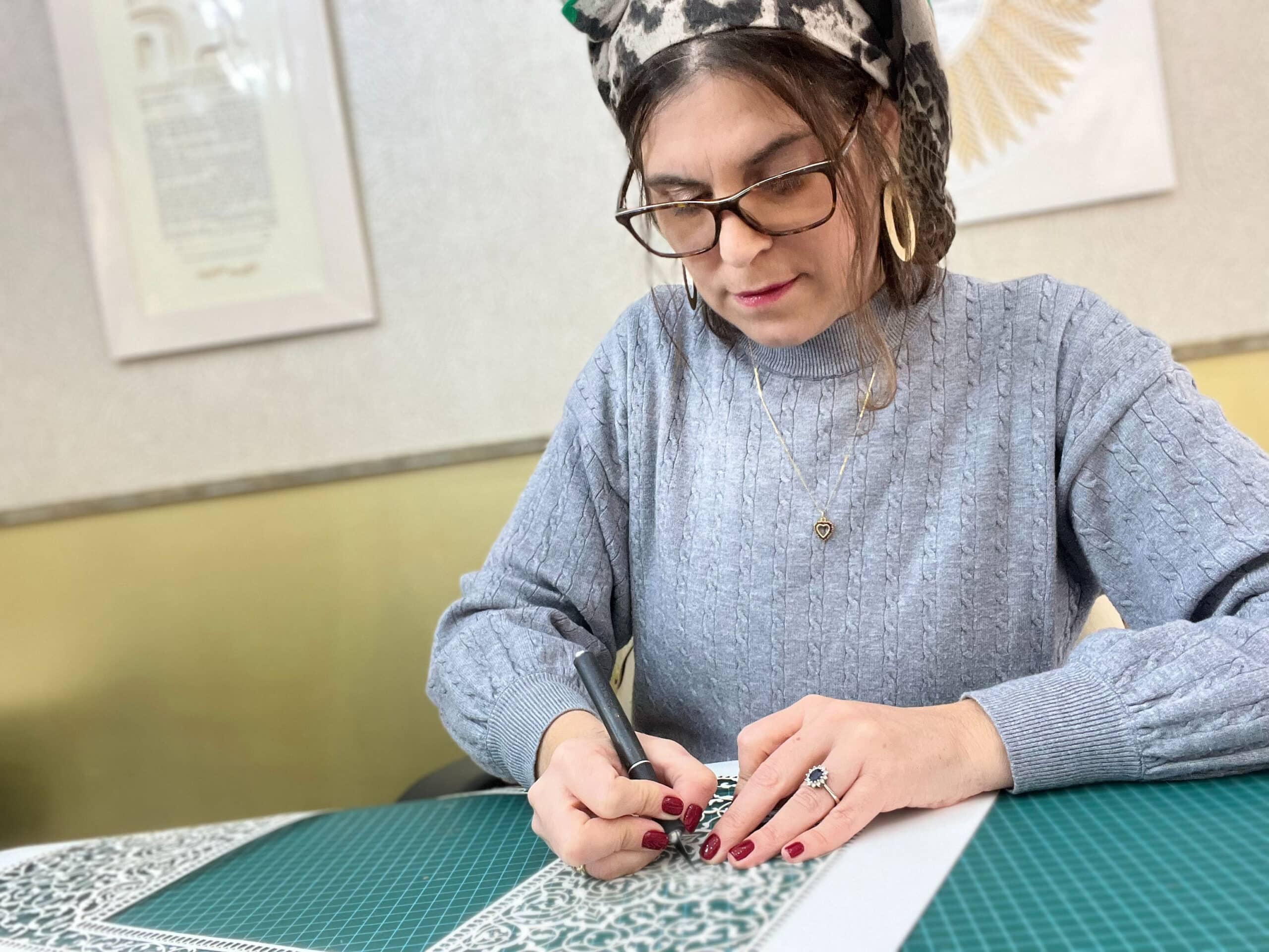 An artist at work, meticulously designing a customized Ketubah